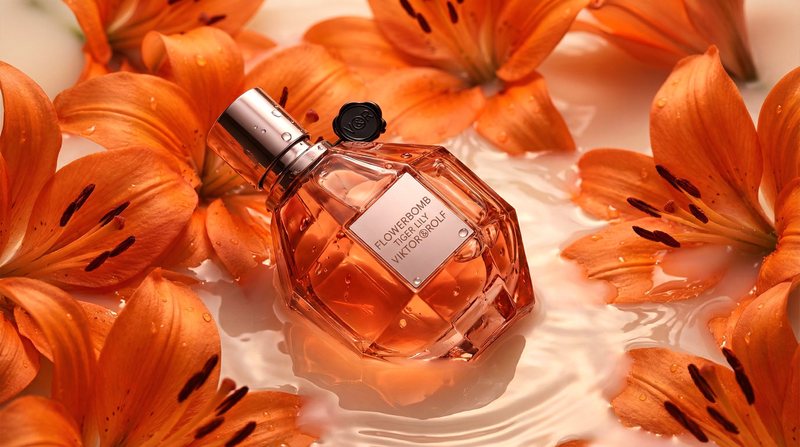 AI-generated concept still of a Flowerbomb Tiger Lily perfume bottle resting in milky water surrounded by orange tiger lilies